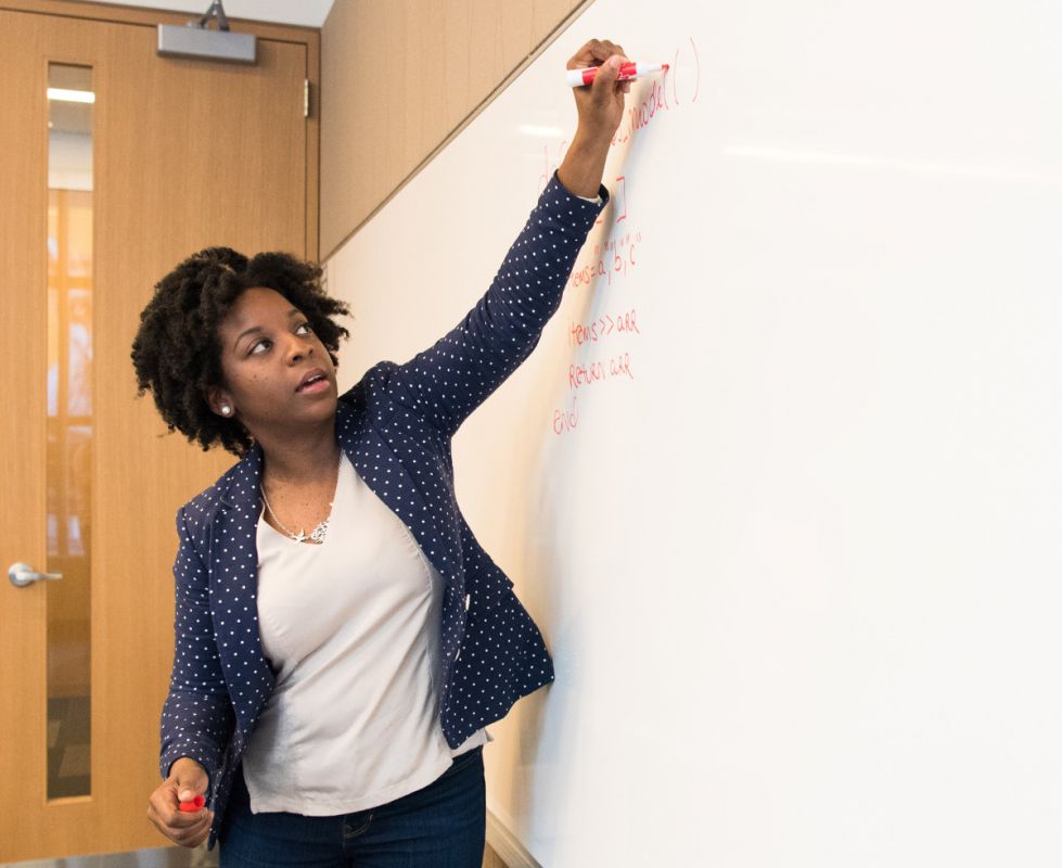 woman writing on a whiteboard